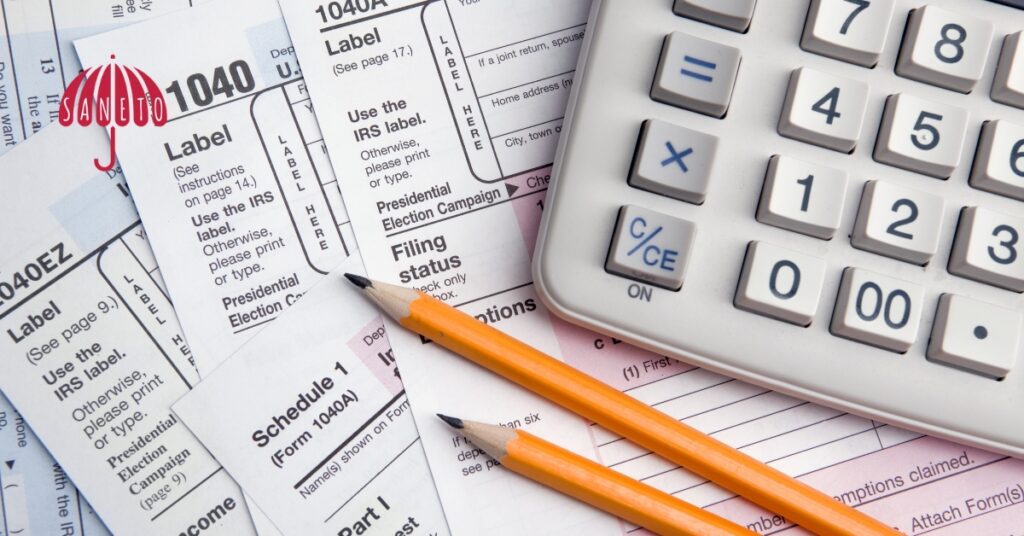 Daňové formuláře s kalkulačkou a tužkami – ilustrace k tématu DPH u pronájmu nemovitostí